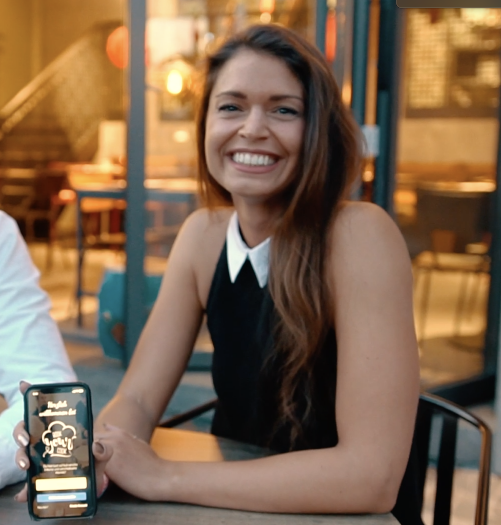 Tanja Knittel präsentiert bookyourcook auf dem Handy in Dortmunder Innenstadt